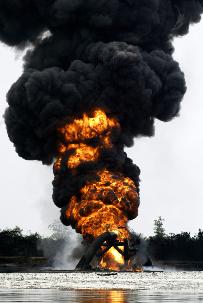 Smoke and flames billow from a burning oil pipeline belonging to Shell Petroleum Development Company across the Opobo Channel in Asagba Okwan Asarama about 50km south-west of Port Harcourt, Nigeria, Thursday, Dec. 22 2005.Investigators are probing the source of a fire that was still blazing Wednesday on a ruptured Royal Dutch Shell oil pipeline in southern Nigeria as the company announced further petroleum production cuts.Residents near the conduit in Nigeria's strife-riven south said suspected militia fighters blew up the pipeline southwest of Port Harcourt Tuesday with dynamite, sparking a conflagration that killed eight. Photo/George Osodi)